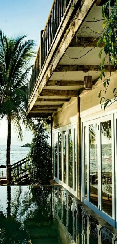 Tropical beachfront house with ocean view and palm trees.