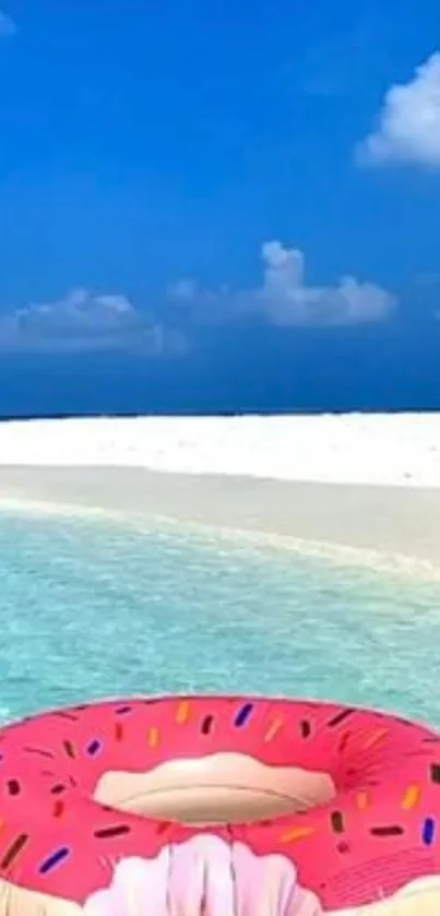 Pink donut float on turquoise beach water under a clear blue sky.