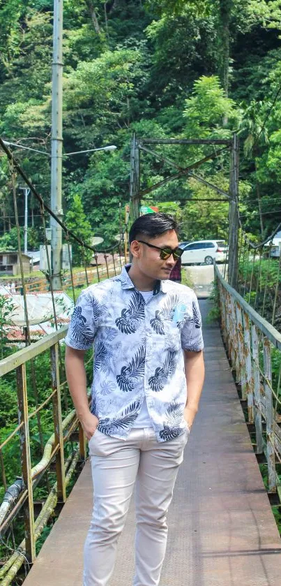 Man walking on a bridge in a tropical nature scene with lush greenery.