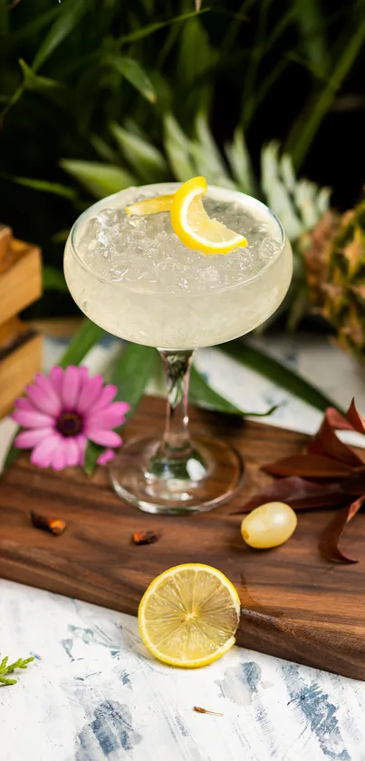 Tropical cocktail with fruits and flowers on a wooden board.