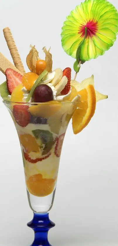 Colorful tropical fruit dessert in a glass with vibrant garnishes.