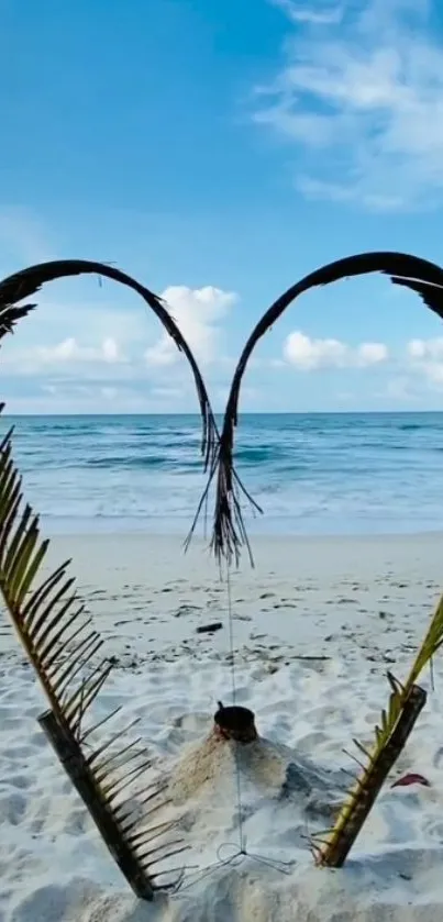 Heart-shaped palm leaves on a tropical beach with ocean view.