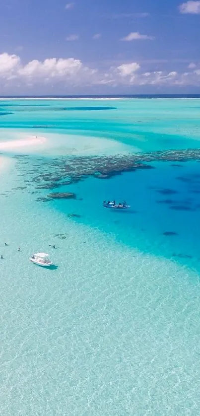 Aerial view of turquoise sea and white sandy beach on a tropical island.