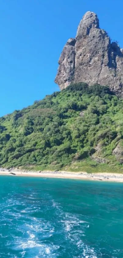 Tropical island with lush green hills and clear blue waters under a bright sky.