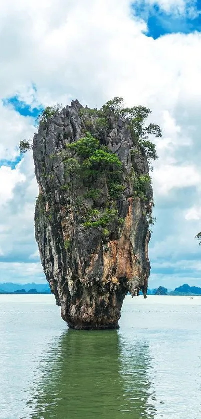 Tropical island with towering rocks and blue water under a bright sky.