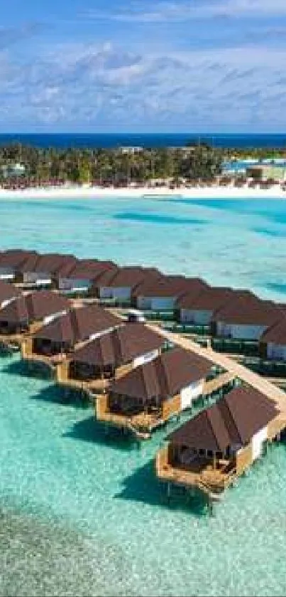 Overwater bungalows on turquoise ocean at tropical island.