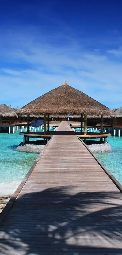 Tropical island beach hut with turquoise waters and blue sky.