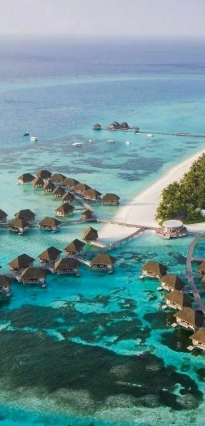 Aerial view of tropical island resort with overwater bungalows.