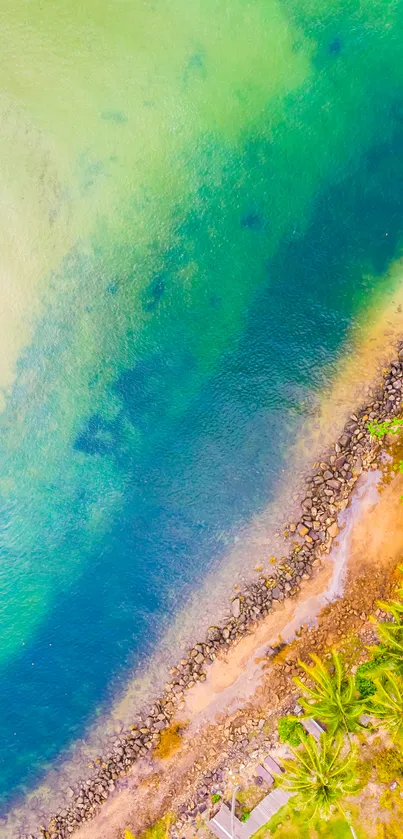 Aerial view of tropical beach with turquoise water and lush greenery.