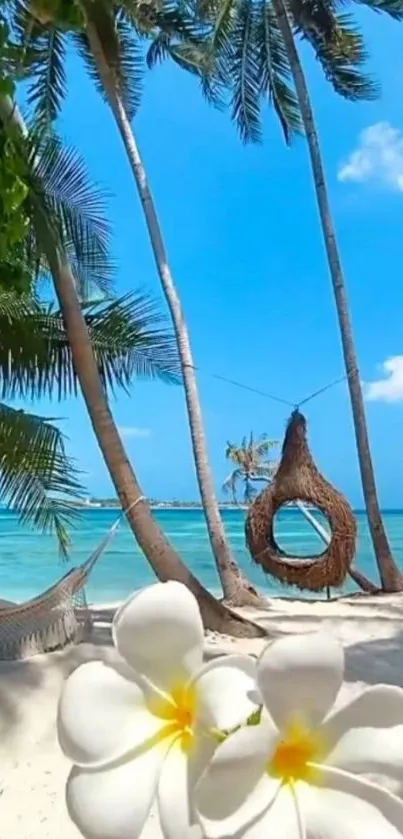 Scenic tropical beach with flowers, palm trees, and hammock.