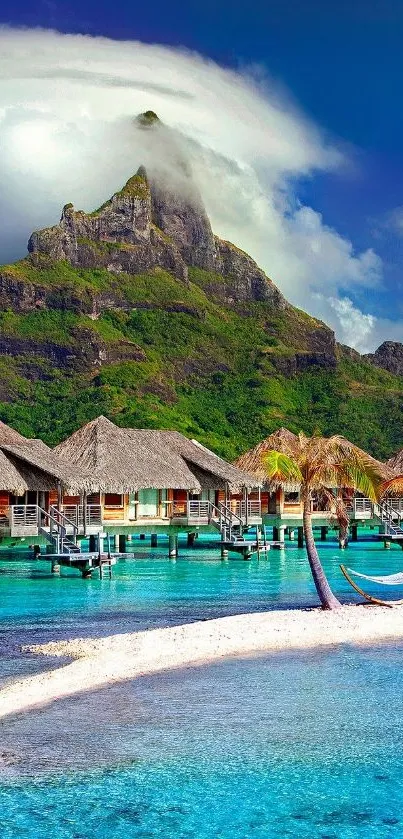 Gorgeous tropical paradise with ocean, beach, huts, and mountain under blue sky.