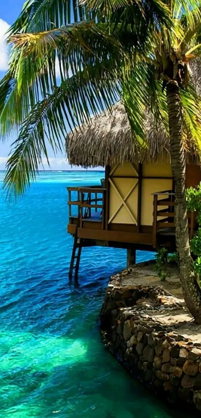 Tropical bungalow and palm tree by turquoise ocean.