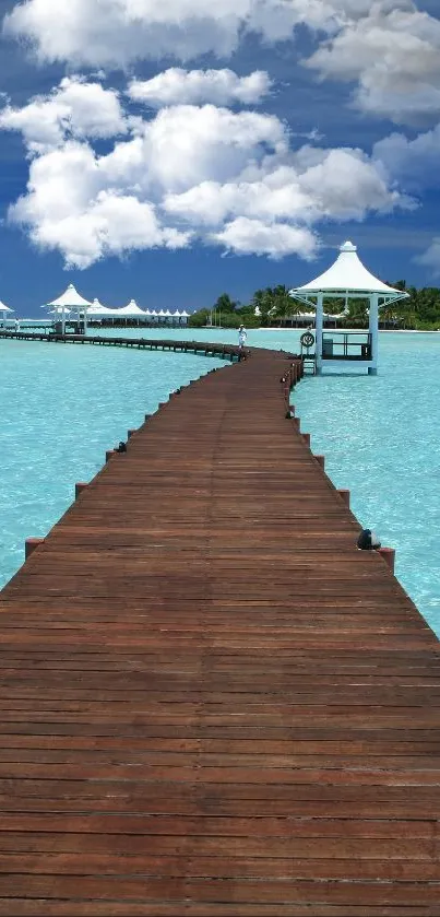 Tropical pier extending over blue waters under a clear sky.