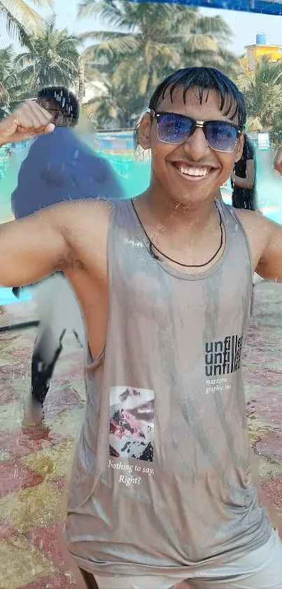 Smiling person flexing by a tropical pool.