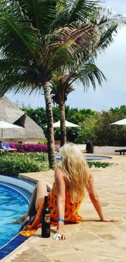 Woman by the pool under palm trees in a tropical setting.