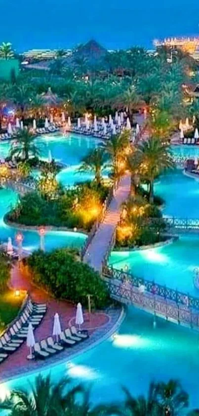 Nighttime tropical resort with illuminated pools and palm trees.