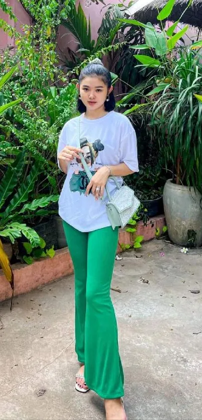 Woman in stylish outfit with tropical greenery.