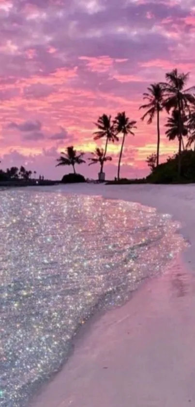 Tropical beach at sunset with pink sky and palm trees.