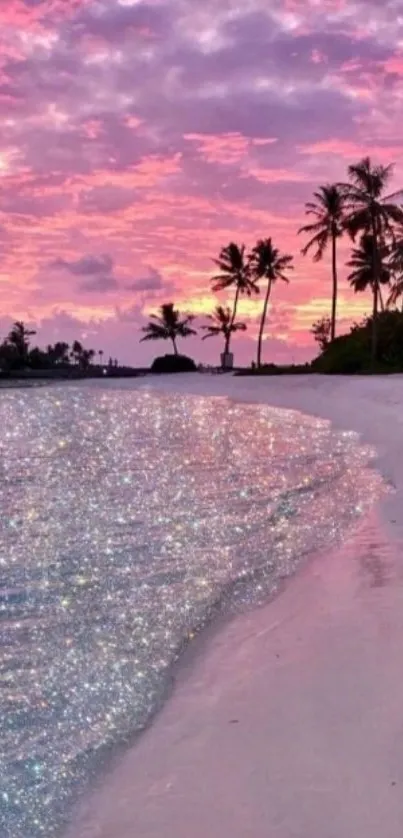 Vibrant pink sunset over a tropical beach with palm trees.