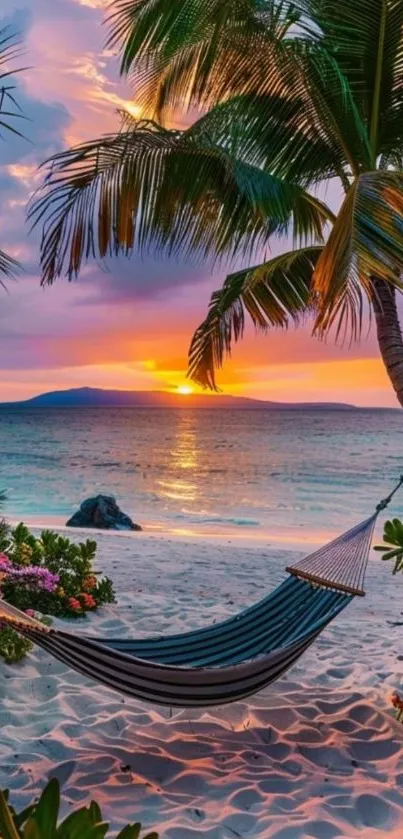 A tropical beach at sunset with palm trees and a hammock.