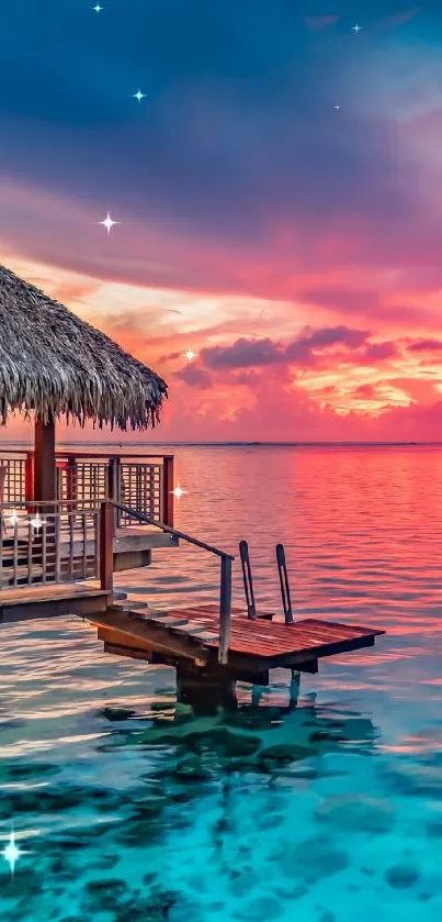 Tropical sunset with overwater bungalow and pink skies.