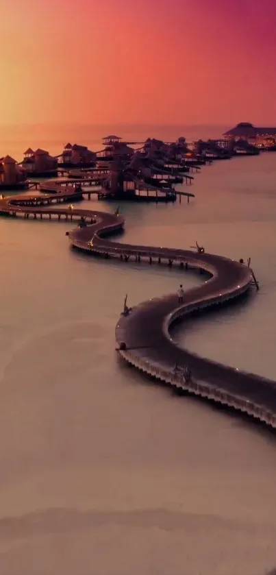 Sunset overwater villas with winding path and pink sky.