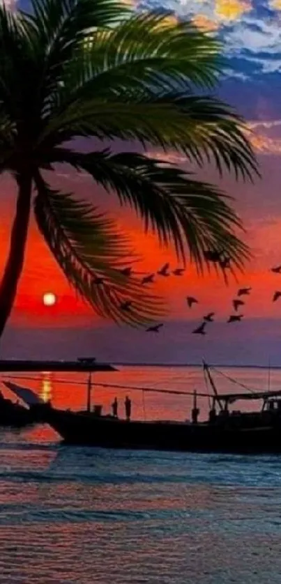 Tropical sunset with palm tree and boat silhouette over ocean.