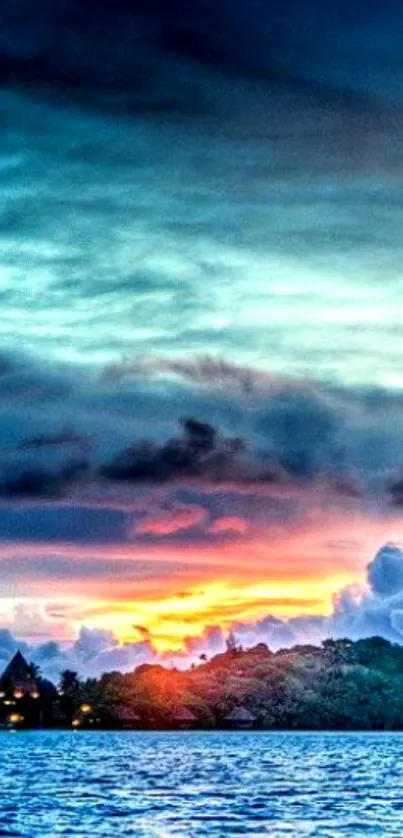 Tropical sunset over ocean with island silhouette.