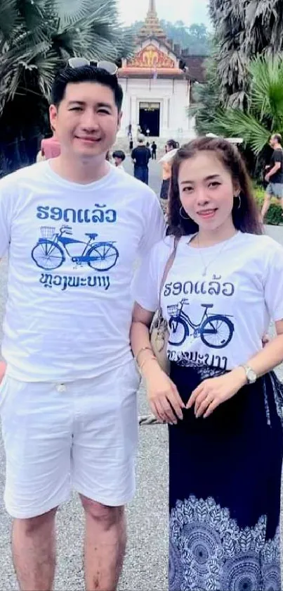 Couple in white outfits at a tropical temple.