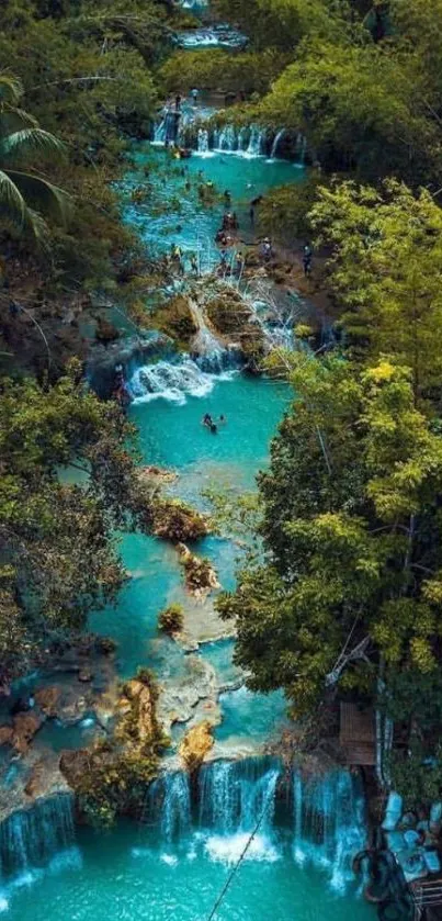 Aerial view of a turquoise waterfall in tropical forest.