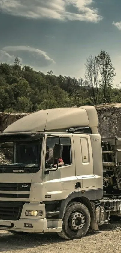 Truck driving through scenic landscape with trees and blue sky.