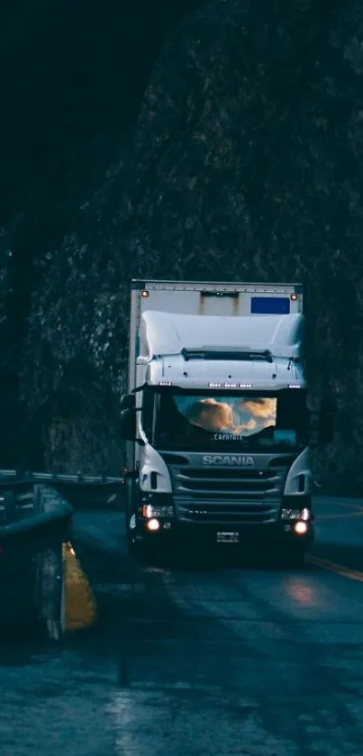 Truck navigating on a dark mountain road at night.