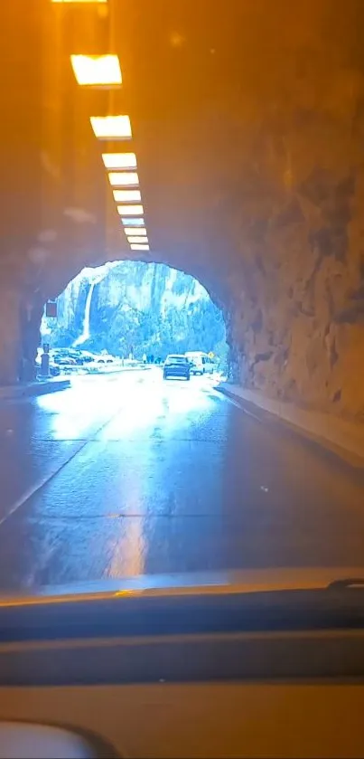 Driving through an illuminated tunnel revealing a breathtaking landscape view.