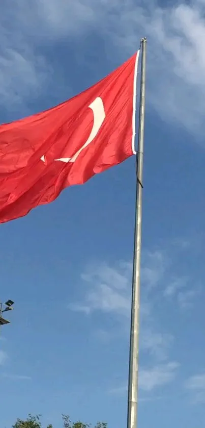 Turkish flag waving against a clear blue sky.