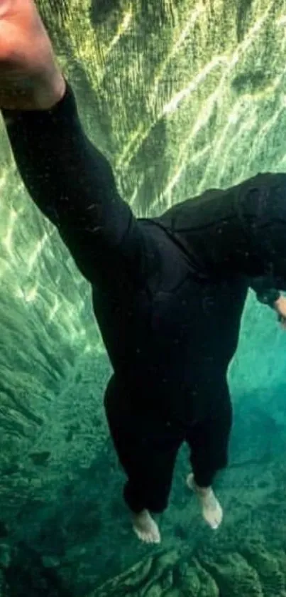 Diver in a black wetsuit exploring underwater scenery.