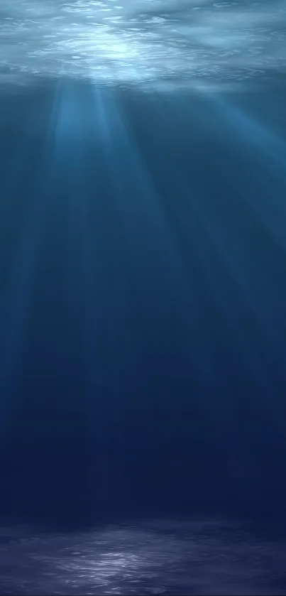 Serene underwater light rays in deep blue ocean theme.