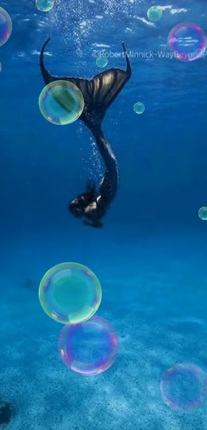 Enchanting underwater scene with mermaid in deep blue ocean.