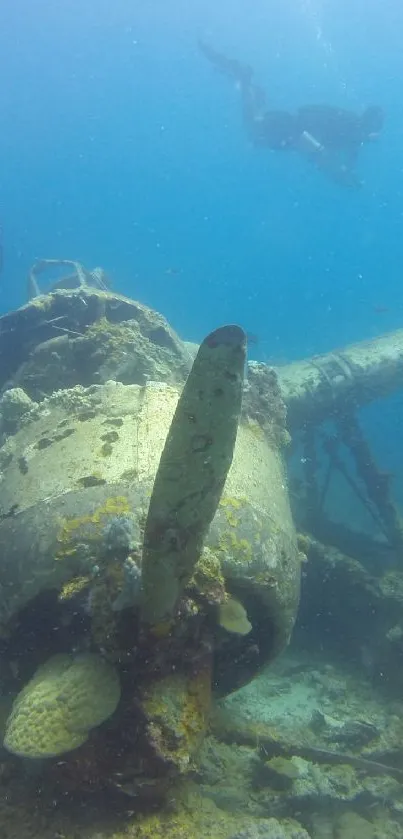 Underwater scene with plane wreck and divers in blue ocean depths.
