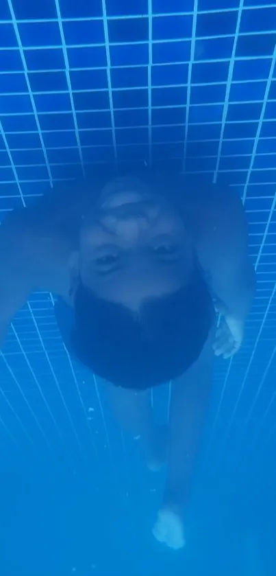 Child swimming underwater in a clear blue pool.