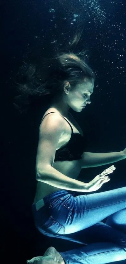 Elegant underwater pose in serene blue hues, perfect for mobile wallpaper.