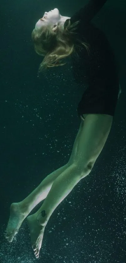 Graceful woman underwater in dark teal ambiance.