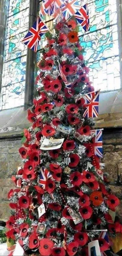 Christmas tree with poppies and Union Jacks against a stone wall.