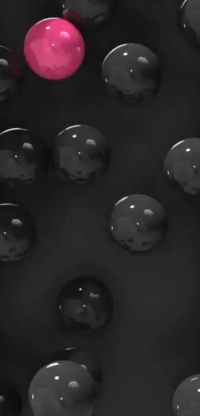 Glossy black spheres with a standout pink sphere mobile wallpaper.