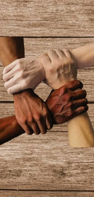 Five diverse hands united against a wooden backdrop.