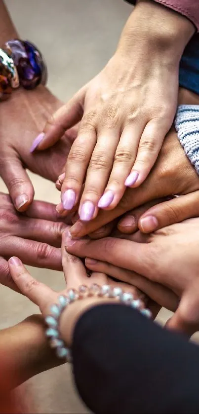 A group of diverse hands joined together symbolizing unity.