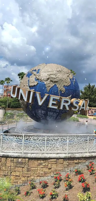 Universal globe at theme park with blue sky background.