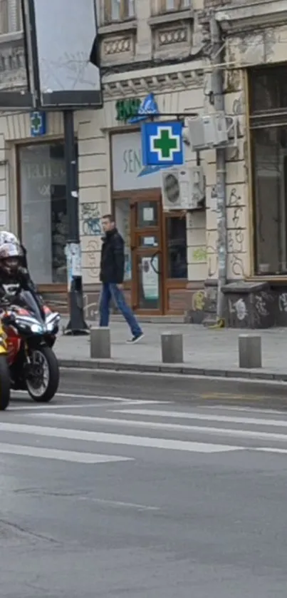 Motorcyclists riding through a lively urban street.