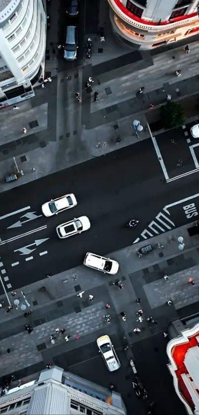 Aerial view of a busy city street with cars and pedestrians.