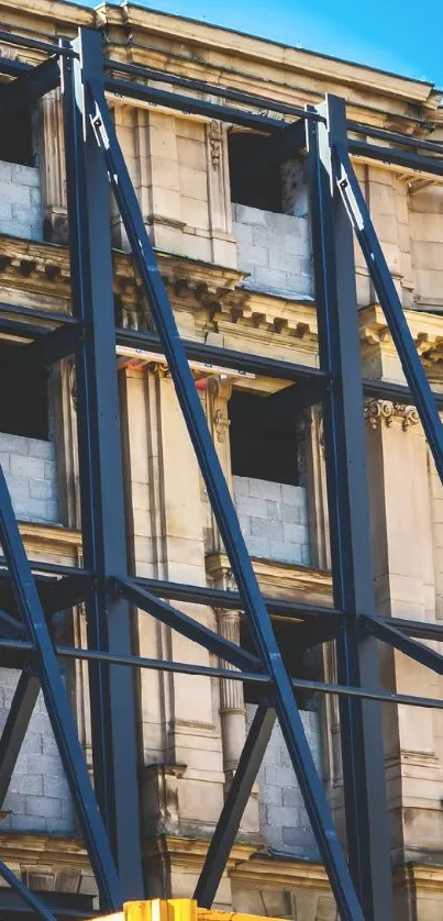 Urban building with steel scaffolding against blue sky.