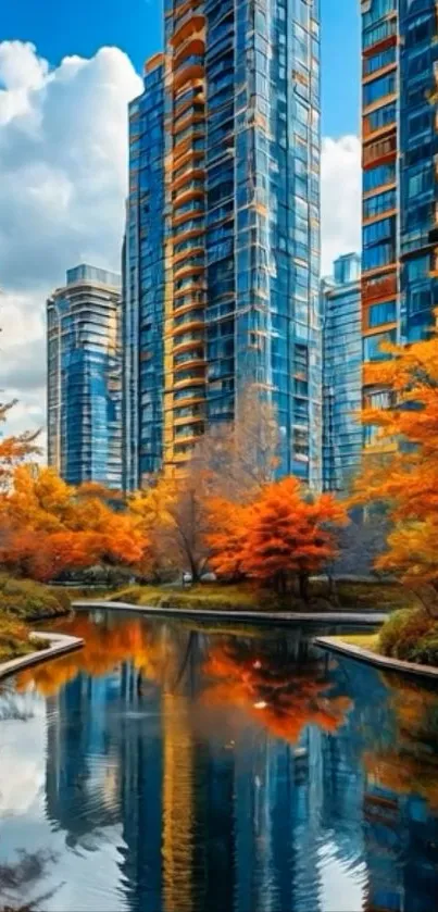 City skyscrapers with autumn trees reflecting in a pond.